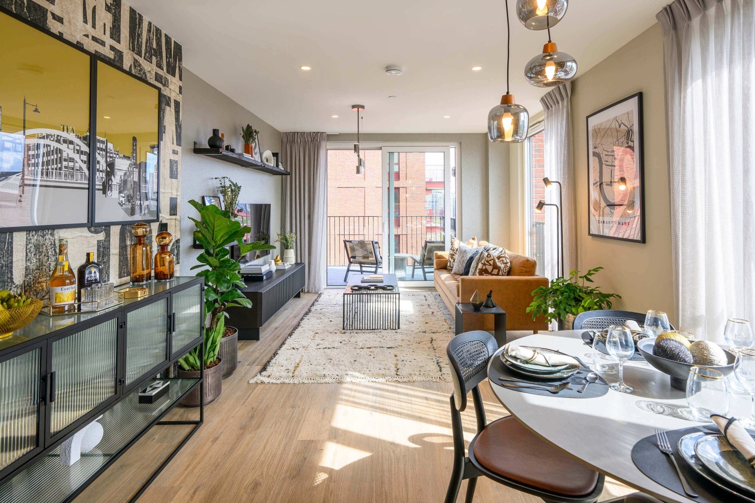 Open plan living room and kitchen inside an apartment at Heron Wharf