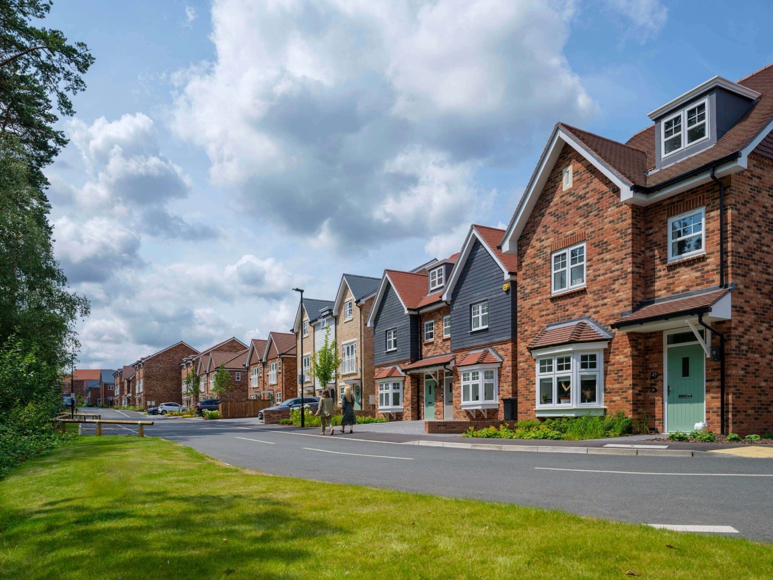 Terraced houses with brick and grey timber fronts at Hartland Village, Fleet