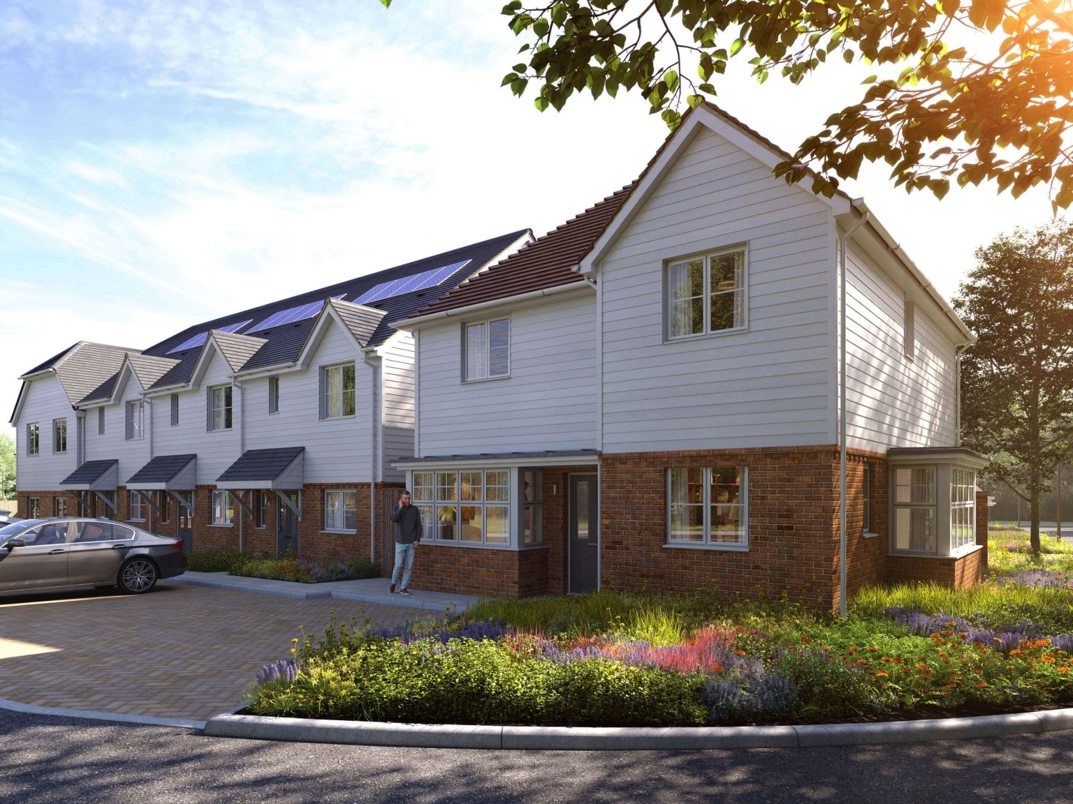 White clad terraced houses with solar panels on the roofs at Foal Hurst Green, Kent