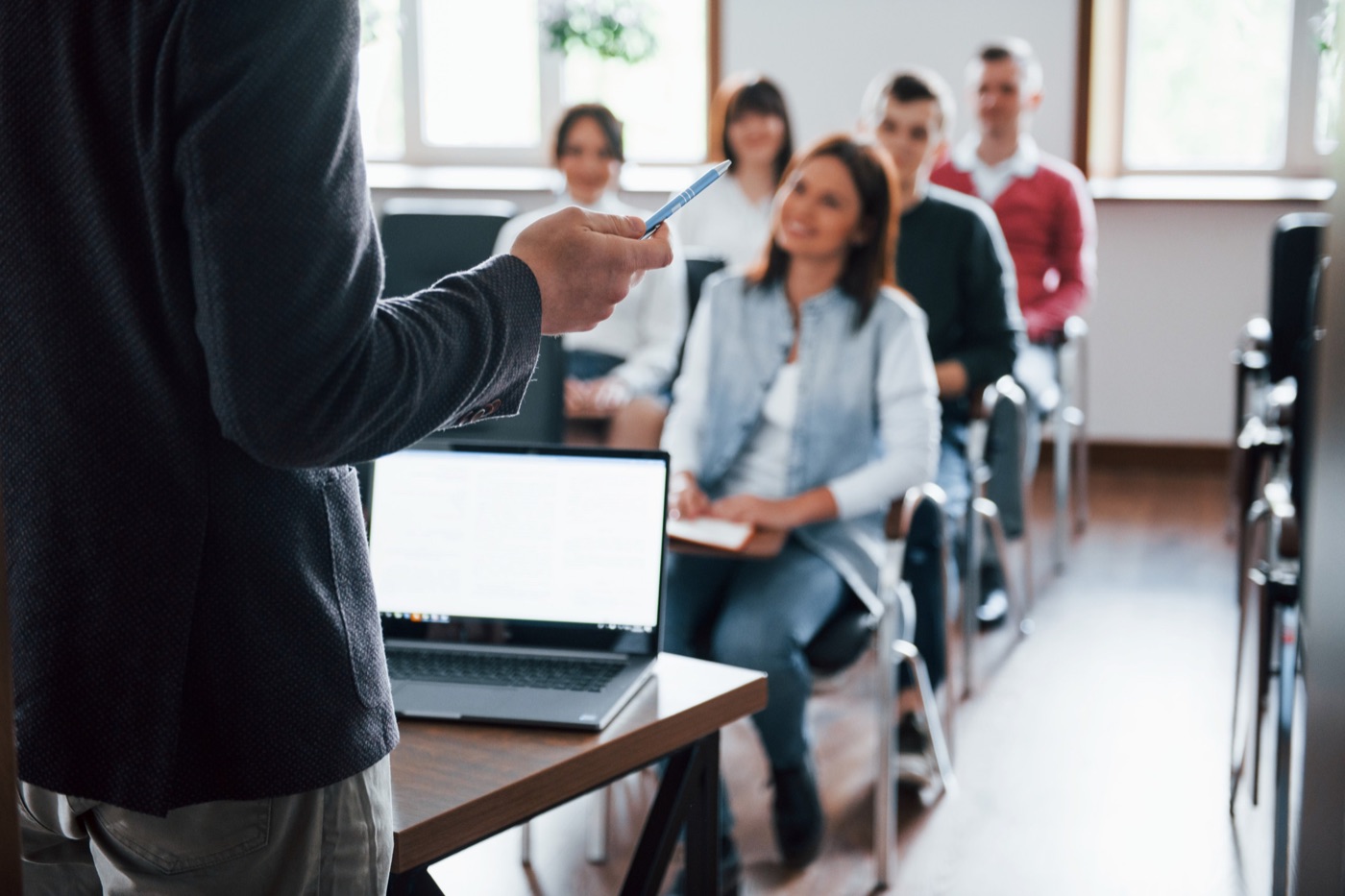 An education consultant giving a classroom presentation to a group of students on UK university applications