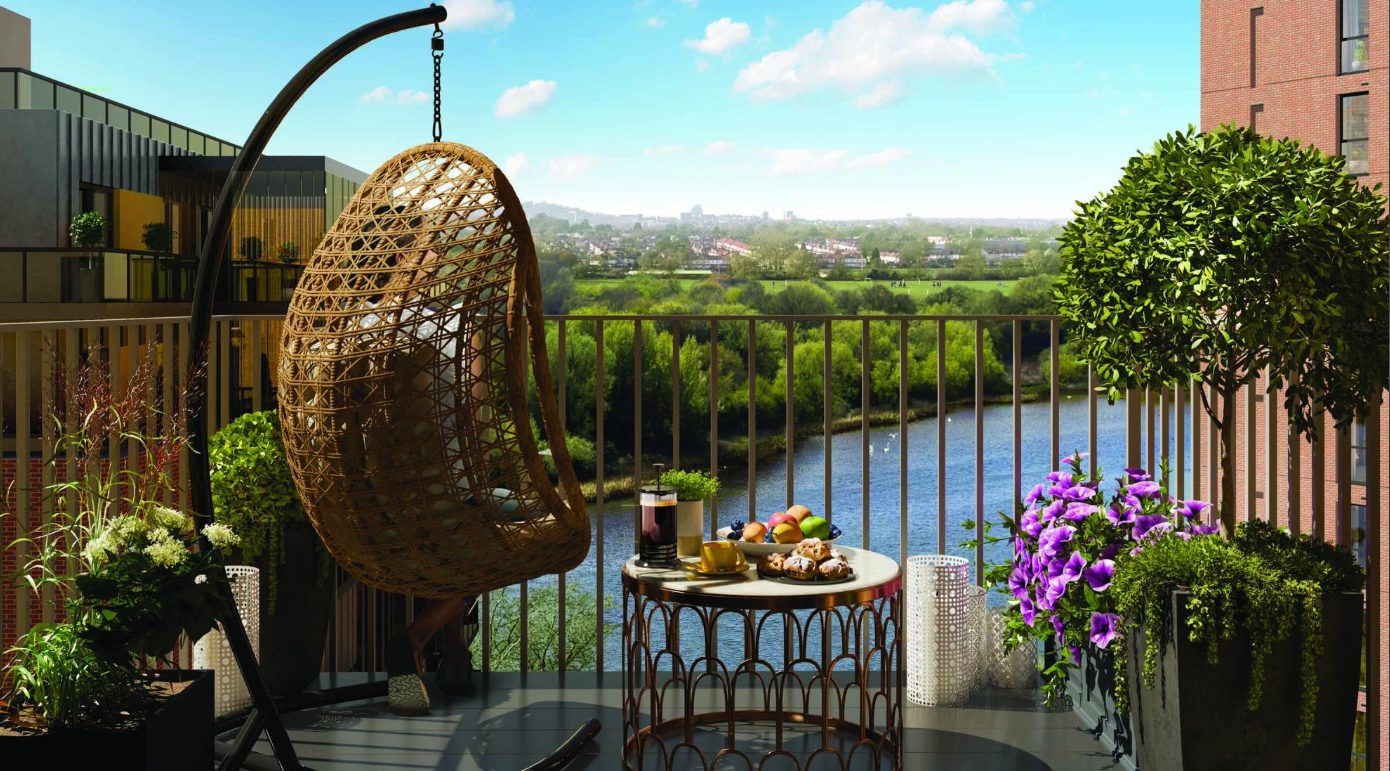 A balcony with a swing seat and flowers overlooking the lake at Hendon Waterside