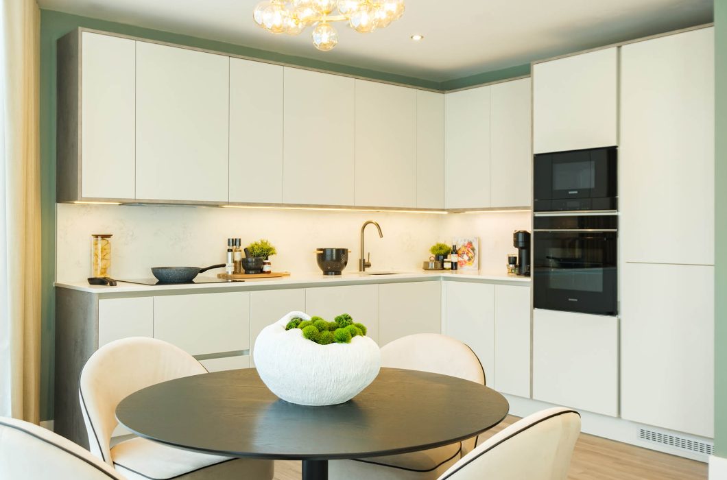 An open kitchen with a dining table at Colindale Gardens